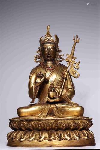 A CHINESE GILT BRONZE INLAID GEMSTONES FIGURE OF BUDDHA STAT...