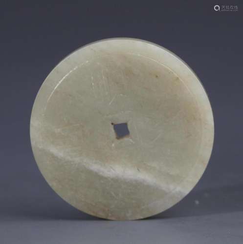 A FINE PALE CELADON JADE COIN FIGURE PENDANT