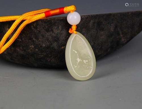 A FINELY CARVED HETIAN GREENISH WHITE JADE PENDANT