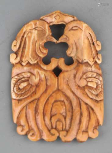 A FINE TOOTH MADE PHOENIX PENDANT