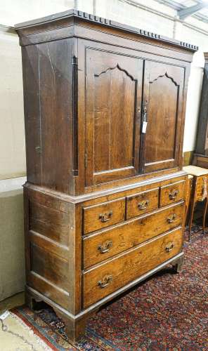 A George III oak press cupboard, with moulded cornice and tw...