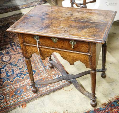 An early 18th century oak lowboy, with single drawer and sal...