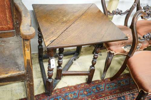 An early 18th century oak drop leaf table, with triangular f...