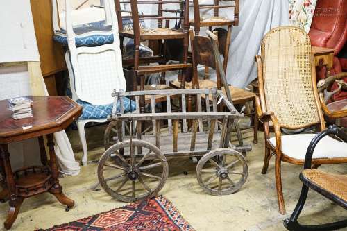 A Victorian oak and beech framed childs cart, with iron boun...