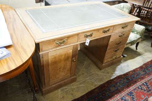 An Edwardian stripped beech pedestal desk, fitted eleven dra...