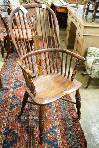 A harlequin set of four Victorian Windsor chairs, comprising...
