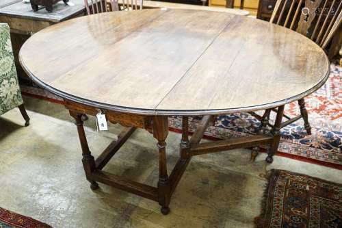A 17th century style oak gateleg table, with oval top and tw...