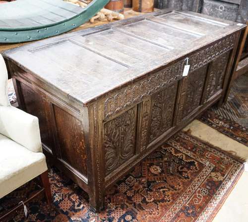 A large 17th century foliate carved oak coffer, length 159cm...