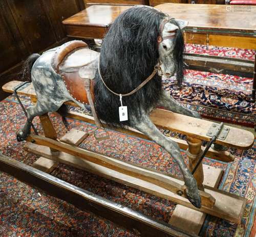 A large Edwardian Ayres type rocking horse on a turned safet...
