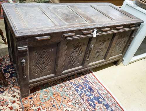 An early 18th century oak coffer, with four panel top and la...