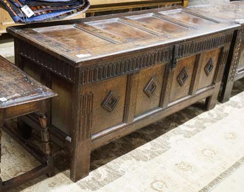 A late 17th century oak coffer, with four panel top and carv...
