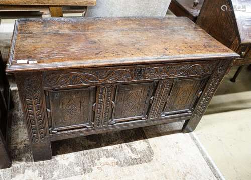 A 17th century oak coffer, with later carved front, length 1...