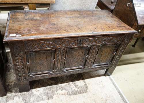 A 17th century oak coffer, with later carved front, length 1...