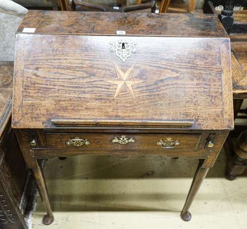 A mid 18th century inlaid oak and elm bureau, with fitted in...