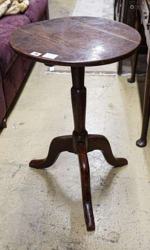 A George III oak tripod table, with circular top and slender...