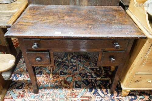 An early 19th century oak low boy, fitted three drawers, on ...