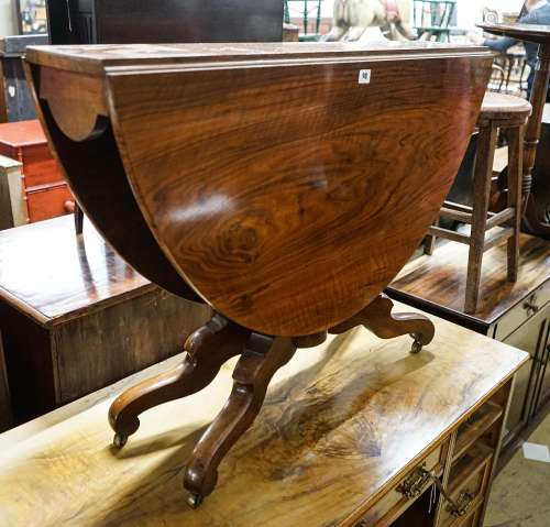 A Victorian figured walnut oval Sutherland table on turned s...