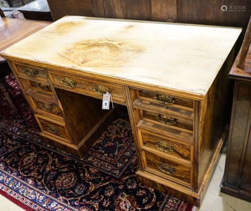 A late Victorian figured walnut twin pedestal desk, fitted w...
