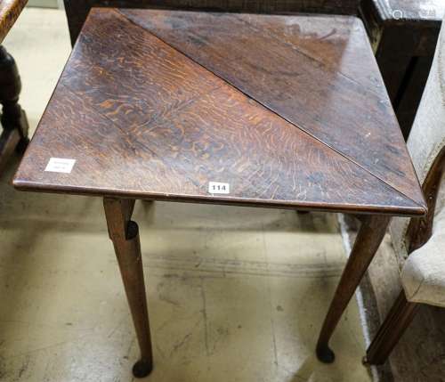 A George II oak folding top tea table, with triangular flap,...
