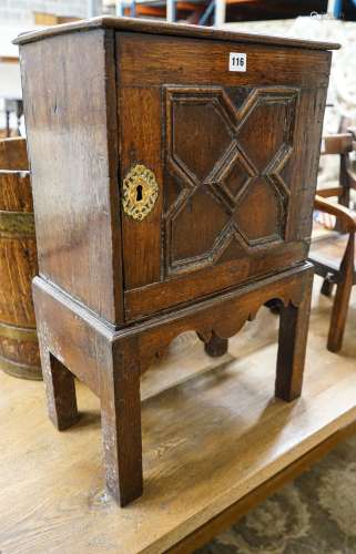 A late 17th century oak spice cupboard, with geometric panel...