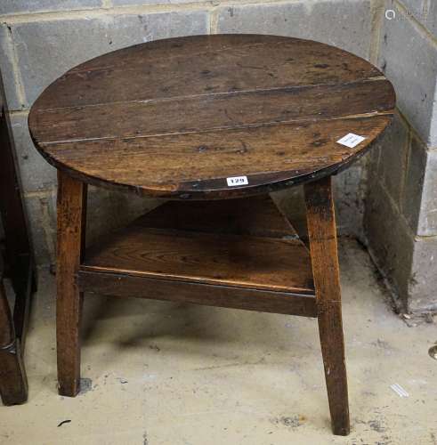 A George III oak cricket table, with circular top and triang...