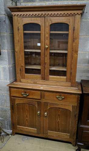 An Edwardian pine dresser, with two glazed doors over two dr...