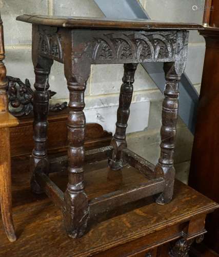 A 17th century style oak joint stool, with foliate carved fr...