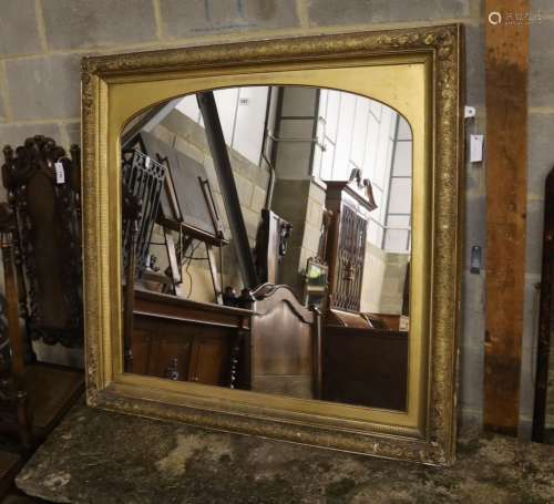 A giltwood and gesso overmantel mirror with arched plate, wi...