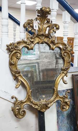 An 18th century Italian carved giltwood cartouche wall mirro...