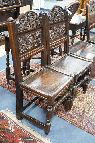 A pair of 17th century Lancashire carved oak side chairs, wi...