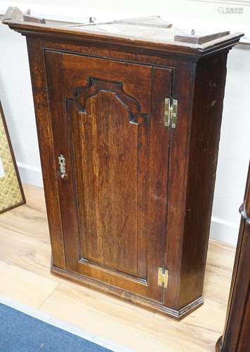 An 18th century panelled oak hanging corner cabinet, width 6...