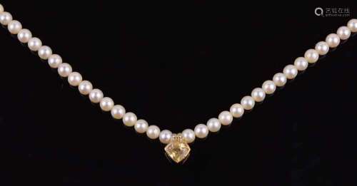 Uniform row of cultured pearls