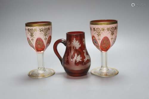 A pair of Bohemian overlaid glass goblets and a wheel engrav...