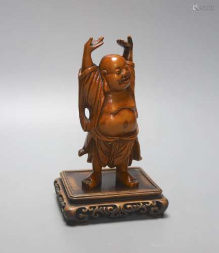 A Chinese boxwood figure of Budai standing, on a hardwood st...