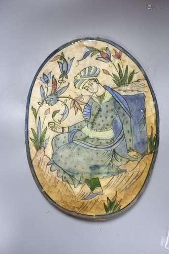 A Persian oval polychrome tile, Qajar dynasty 36cm