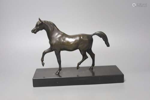A bronze figure of a prancing horse, on a black marble plint...