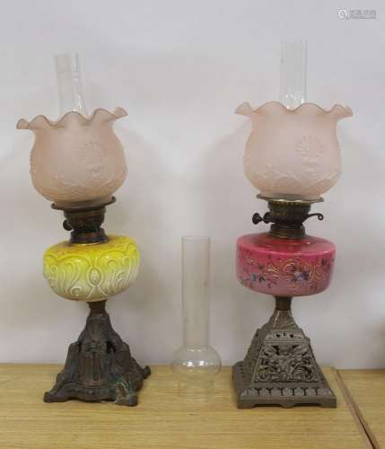 Two late Victorian brass mounted oil lamps with pink and yel...