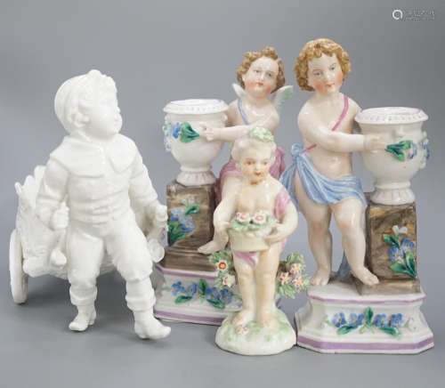 A pair of Continental porcelain cherub candlesticks, 13.5cm,...