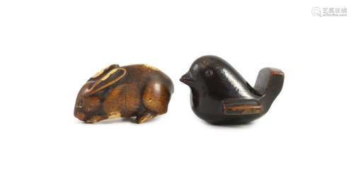 A Japanese lacquered wood netsuke of a bird and a wooden net...
