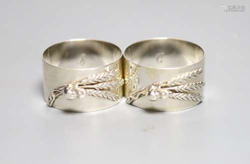 A modern pair of silver napkin rings cast with mice and whea...