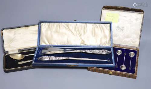 A cased set of six silver bean end coffee spoons, a cased si...