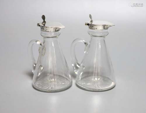 A pair of George V silver mounted glass whisky tot jugs, Huk...