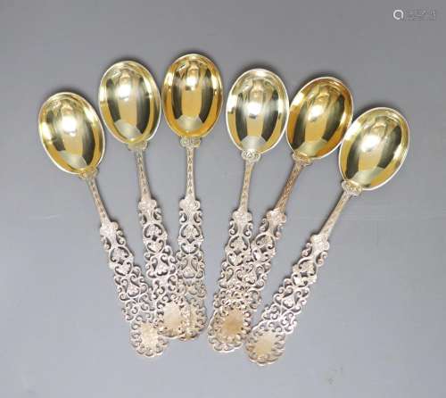 A set of six silver coffee spoons, with fancy pierced stems,...