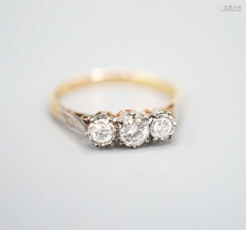 A modern 18ct gold and three stone diamond ring, size Q/R, g...