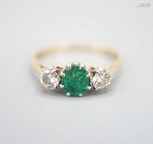 An 18ct and plat, emerald and diamond set three stone ring, ...