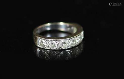 A modern white gold and channel set seven stone diamond half...