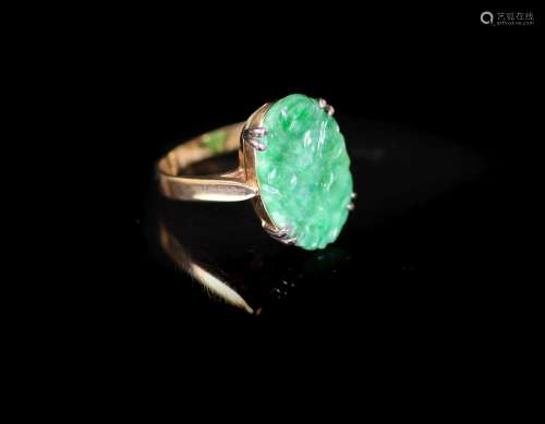 A mid 20th century gold and carved oval jade set dress ring,...
