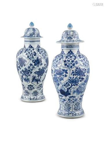 A NEAR PAIR OF BLUE AND WHITE KANGXI STYLE LIDDED VASES Chin...