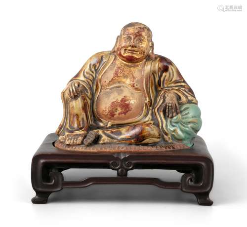 AN ENAMELLED MOULDED CERAMIC SCULPTURE OF A SEATED BUDAI Chi...