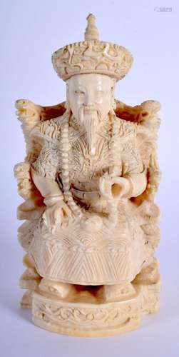 AN EARLY 20TH CENTURY CHINESE CARVED IVORY FIGURE OF AN EMPE...